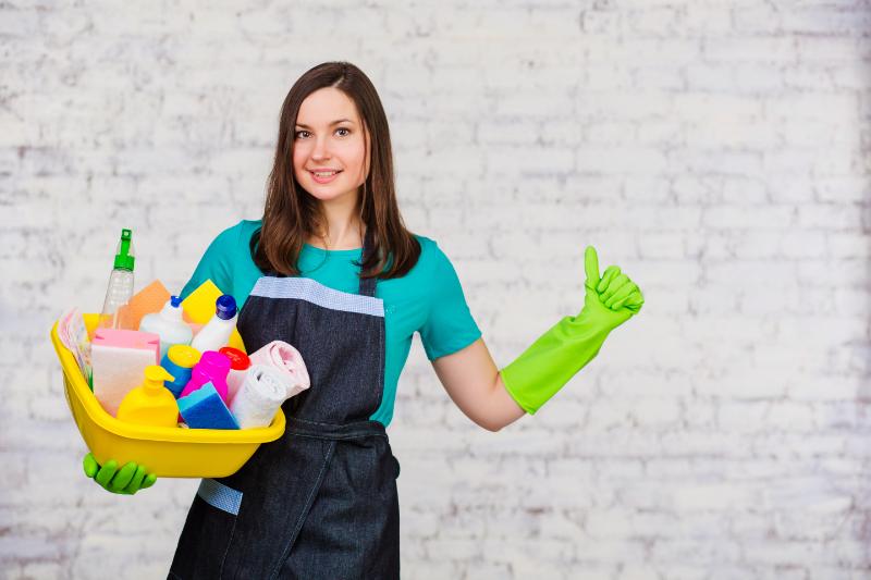 Cleaner posing for a photo while holding cleaning material